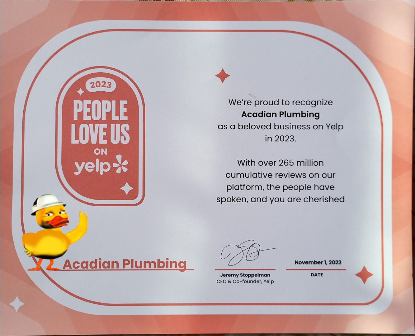 A certificate from Yelp! with Katie the Duck saying that Acadian Plumbing was one of the highest rated businesses on Yelp! in 2023.